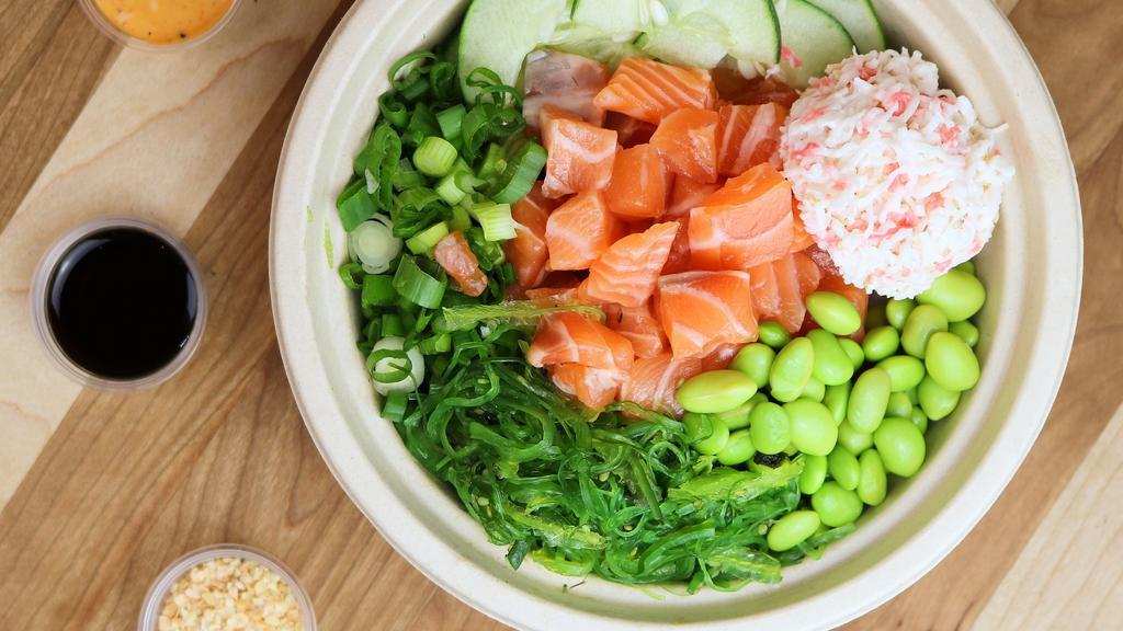 Salmon Supreme Bowl · Scottish salmon, cucumbers, edamame, green onions, red onions, sriracha aioli, citrus ponzu, furikake, and roasted garlic