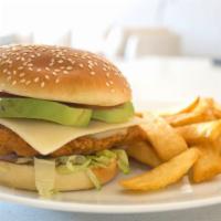 Elegant Avocado Fried Chicken Sandwich · Fine slices of avocado topped on fried chicken breast tenders, mayonnaise, and pickles on a ...
