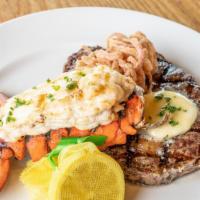6oz. Lobster Tail & New York Steak · mashed potatoes / summer vegetables / onion strings / herb butter