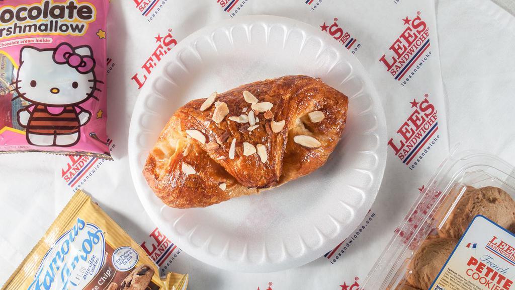 Almond Croissant (Bánh Almond) · Filled with almond cream and sprinkled with sliced almonds.