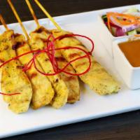 Chicken Satay · Marinated chicken skewers served with peanut sauce and cucumber salad.