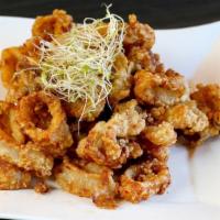 Golden Calamari · Crispy calamari tossed with garlic and Thai smoked chili paste serve with chili vinaigrette.