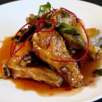 Angel Wings · Crispy chicken wings glazed in chef’s special sweet, smoked Thai chili sauce topped with cri...