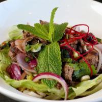 Steak Salad · Grilled sliced beef with red onion, mint leaves, toasted rice powder in Thai chili and lemon...