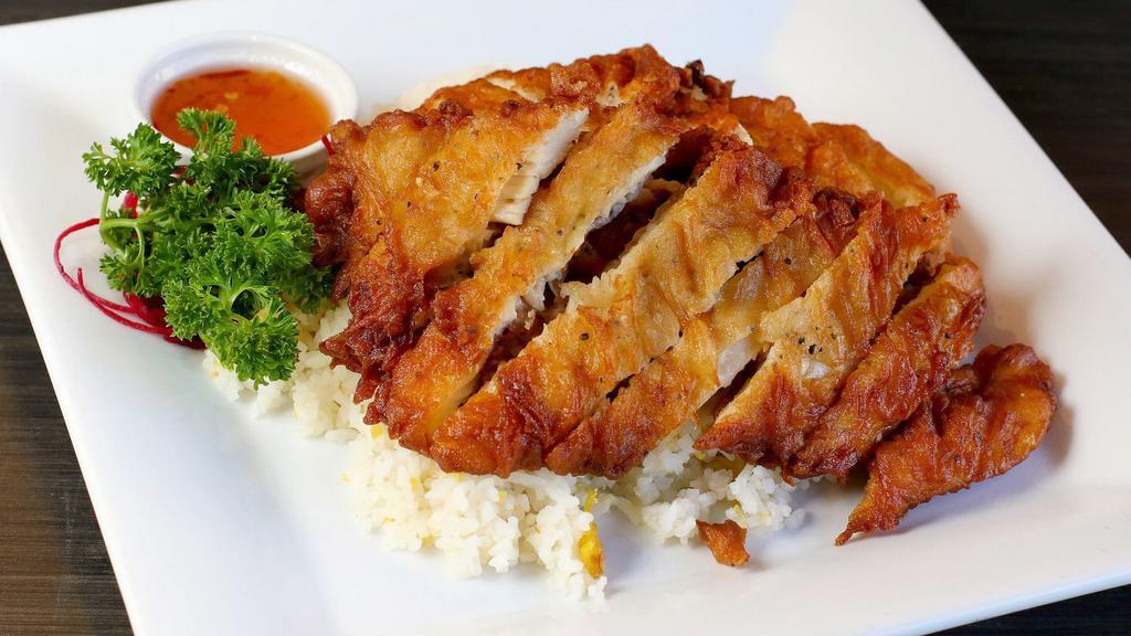 Crispy Chicken & Egg Fried Rice · Marinated crispy chicken on egg fried rice, served with sweet and sour sauce.