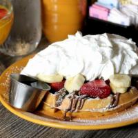 Nutella Waffle · Delicious Nutella, fresh strawberries, banana, topped whipped cream and powdered sugar.