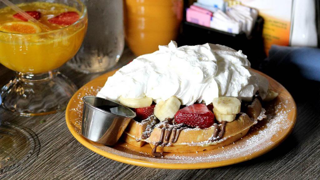 Nutella Waffle · Nutella waffle- topped with nutella, fresh strawberries, banana, whipped cream and powdered sugar.