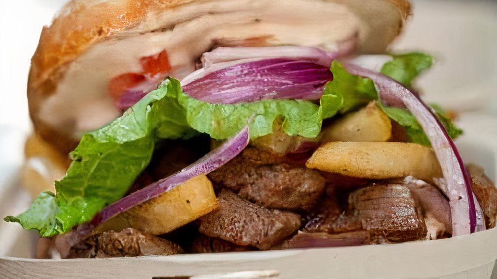 Lomo Saltado Sandwich · Beef tenderloin, tomatoes, onions, pisco-soy reduction with fries and chile rocoto aioli.