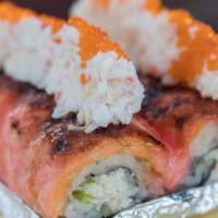 Angry Lion King · CA roll topped with salmon and special sauce and baked. Topped with crab meat and tobiko.