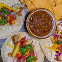 Grilled Mahi Tacos · Grilled Mahi Mahi, citrus jalapeno aioli, slaw mix, mango pico de gallo, corn tortilla. Serv...