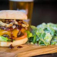 Cowboy Burger · Applewood-smoked bacon, cheddar cheese, BBQ sauce, onion rings, garlic aioli.