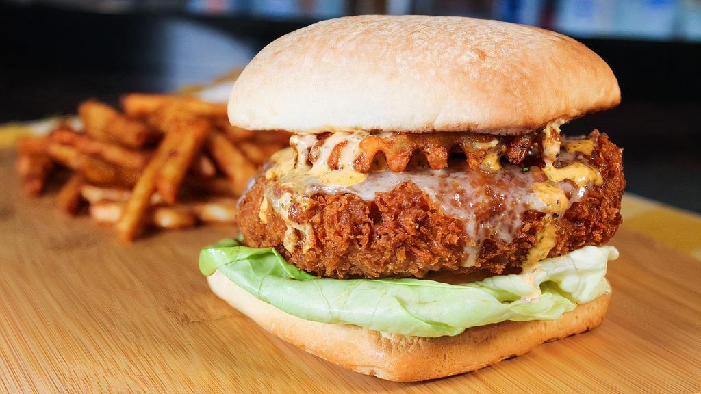 Beer-Battered Burger · Certified Angus beef patty deep-fried in craft beer batter, swiss cheese, citrus jalapeño aioli, lettuce, tomato, topped with waffle fries and spicy ranch.
