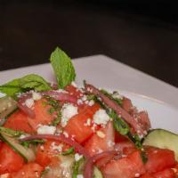 Watermelon Salad · Freshly cut watermelon, cucumber, mint, basil, pickled red onion, all tossed in house made c...