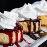 Cheesecake Trio · Three pieces of cheesecake with chocolate, raspberry and caramel sauces.