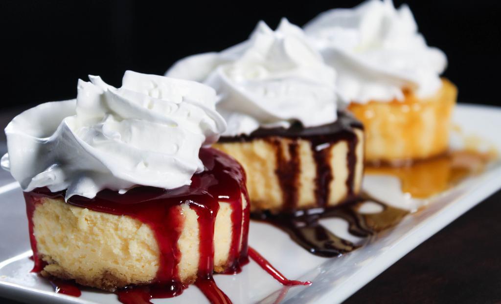 Cheesecake Trio · Three pieces of cheesecake with chocolate, raspberry and caramel sauces.