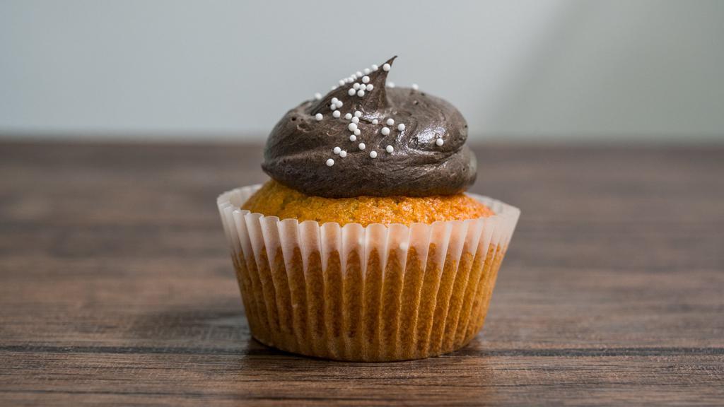 7. Chocolate on Vanilla · Classic fluffy moist vanilla cupcakes topped with a dark rich chocolate frosting.