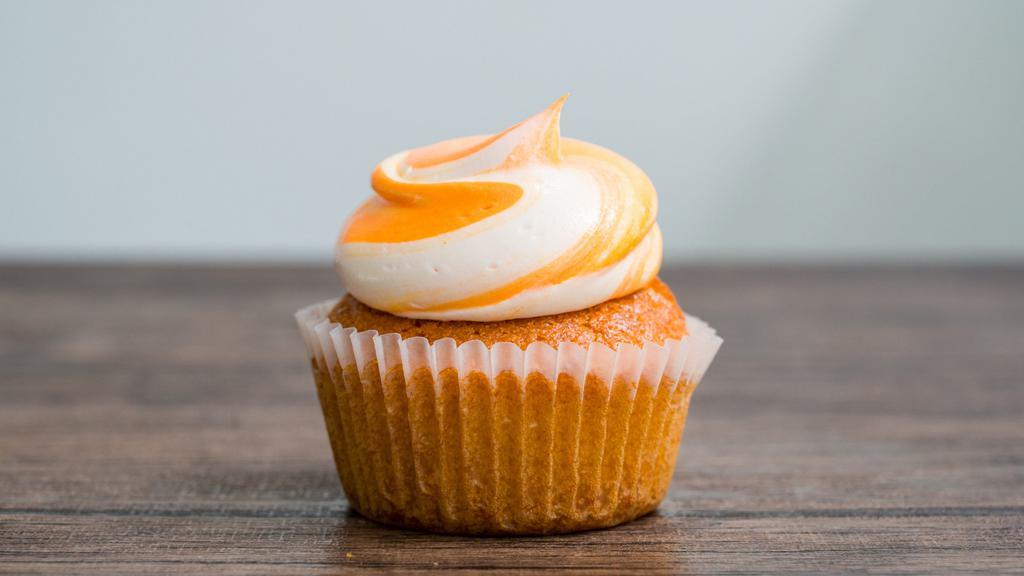 Orange Creamsicle · Soft & fluffy cupcake loaded with orange flavor and topped with an orange swirl buttercream.