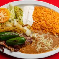 Carne Asada · served with rice, re-beans,lettuce, guacamole, cheese, sour cream and corn or flour tortilla