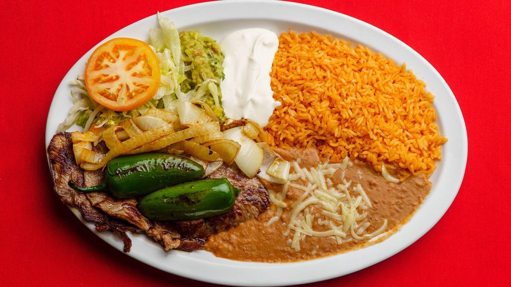 Carne Asada · served with rice, re-beans,lettuce, guacamole, cheese, sour cream and corn or flour tortilla