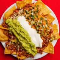 Super Nachos · corn tortilla chips topped with re- fried beans, cheese, choice of meat, guacamole, sour cre...