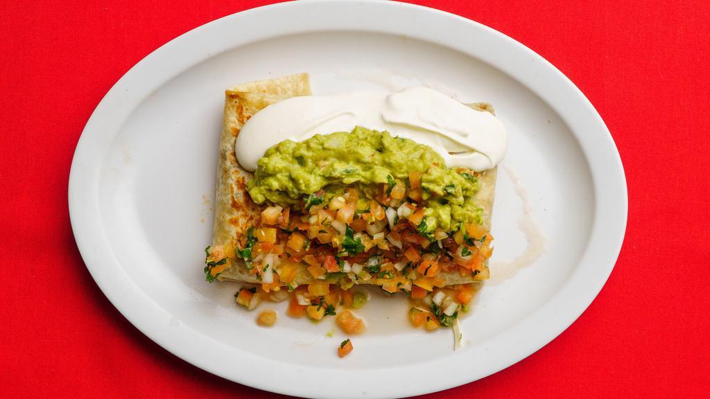 Super Quesadilla · Big flour tortilla with meat, melted cheese topped with guacamole, sour cream and pico de gallo