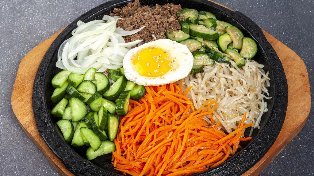 R3. Chul Pan Bi Bim Bab · Rice with crisped bottom, topped with carrot, zucchini,  bean sprouts, cucumber, onion, egg, and your choice of protein.