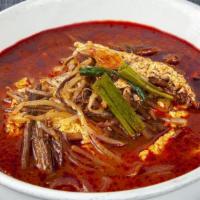 S1. Yook Gae Jang · Spicy beef soup with glass noodle, egg, and vegetables.