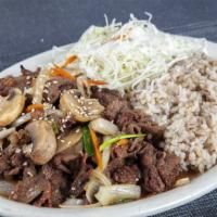 M1. Bul Go Gi Dup Bab · Stir-fried marinated beef with vegetables, rice, and salad.