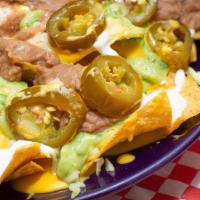 Deluxe Nachos · Chips, refried beans, jalapenos and cheese.