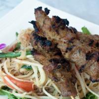 Papaya Salad with Beef Skewers · Tri-tip marinated with Cambodian BBQ sauce, char-broiled. Served with papaya salad. Papaya s...