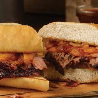 Pit Dip Sandwich · Sliced brisket, pit-smoked caramelized onions, & cheddar cheese on a toasted hoagie bun. Ser...