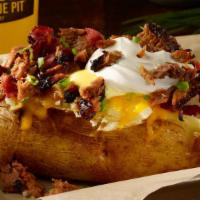 Loaded Giant Baker · A big ole spud filled with your favorite toppings of bacon, cheddar, onions, margarine and s...