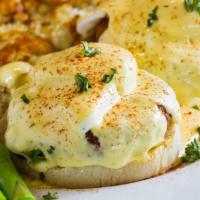 Crab Cakes Benedict · Two authentic crispy crab cakes English muffin, and poached eggs Hollandaise sauce.