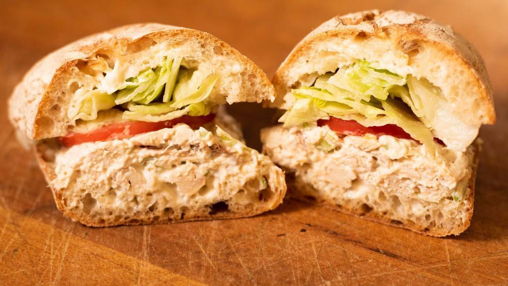 The Classic Chicken Salad · With mayo, iceberg lettuce and tomatoes on ciabatta roll.