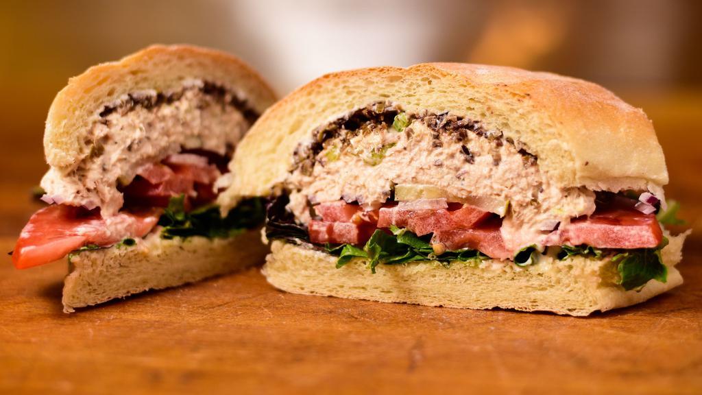 The Classic Albacore Tuna Salad · With mayo, mixed greens, tomato and olive tapenade on soft sourdough roll