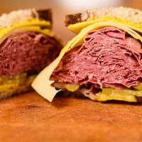 The Classic Pastrami And Swiss · With yellow mustard, pickles and onions  Light Rye bread.