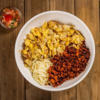 Chorizo Breakfast Bowl · A bowl filled with chorizo, potatoes, fluffy scrambled eggs, cheese, and a side of salsa.