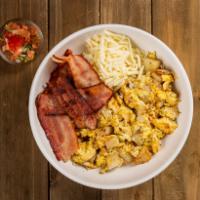 Bacon Breakfast Bowl · A bowl filled with bacon, potatoes, fluffy scrambled eggs, cheese, and a side of salsa.