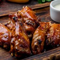 The Tangy BBQ Wings · Golden-crispy golden chicken wings with sizzling BBQ sauce made to perfection.