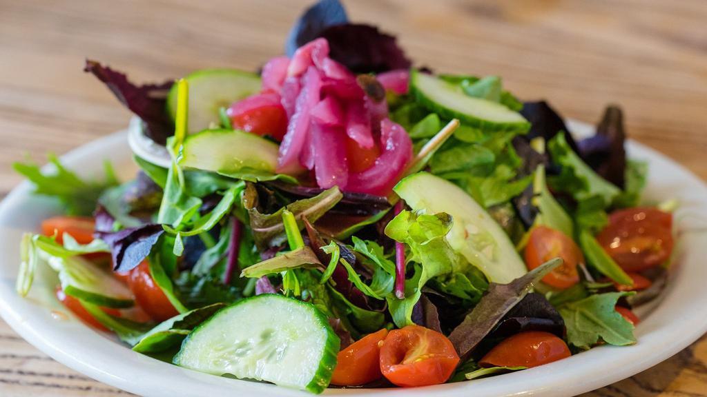 House Salad · Mixed greens, tomatoes and cucumbers tossed with our house-made vinaigrette.