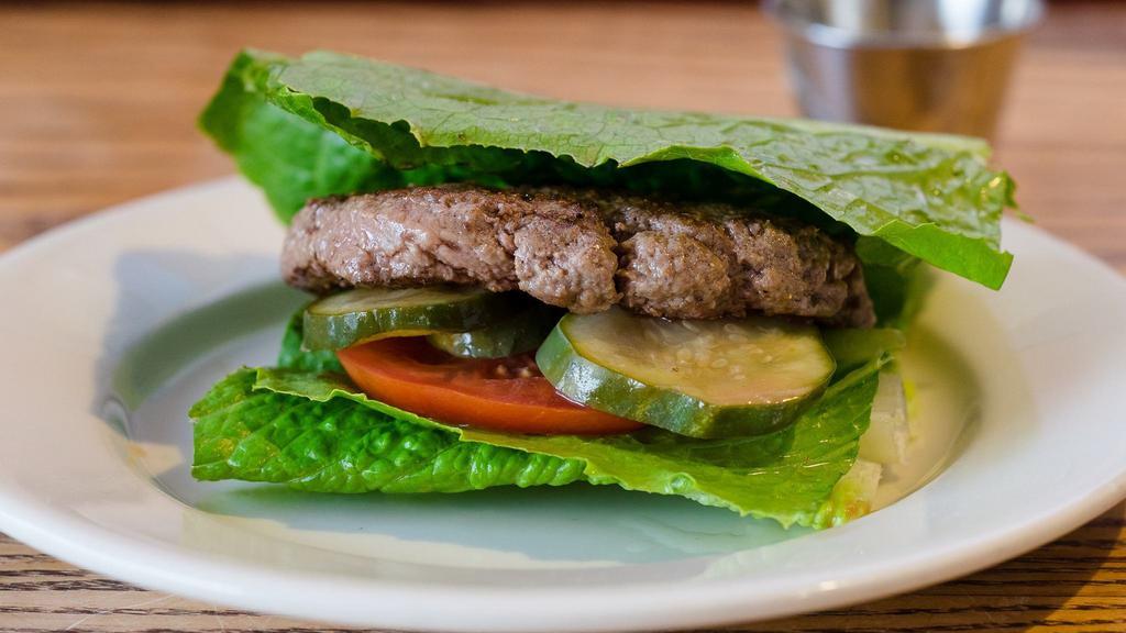 Barefoot in the Park Burger · Bread free burger wrapped in romaine lettuce. Served with house pickled red onions, lettuce, tomatoes, house-made garlic and infused aioli. Cooked medium.
