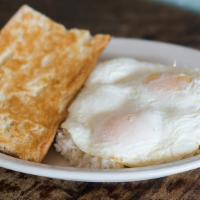 Arroz con Huevos · Eggs over rice. Served with toast.