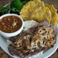 Bistec Encebollado · Thinly sliced steak with sauteed onions served with salad, rice, beans, and plantains.