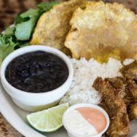 Camarones Empanizados · Plantain-fried prawns served with salad, rice, beans, plantains, fresh lime, and sauce for d...