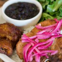 Chuletas Fritas · Thin cut pan friend pork chops served with salad, rice, beans, and plantains.