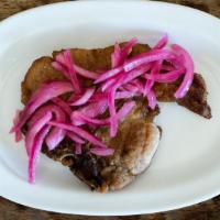 Chuleta a la Carta · 1 piece. Thin cut, pan-fried pork chop. Served with pickled pink onions.