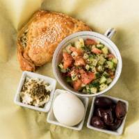 Israeli Breakfast · Boureka of the day (savory puff pastry) served with egg, Israeli chopped salad, Kalamata oli...