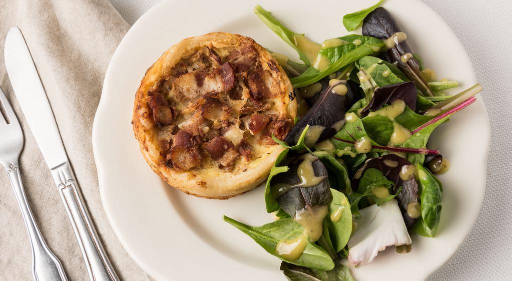 Quiche Of The Day · Slice of house made Quiche, served with greens