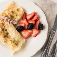 Breakfast Crepe · Crepe filled with scrambled egg and cheese. Add ham or spinach. Served with fruit.