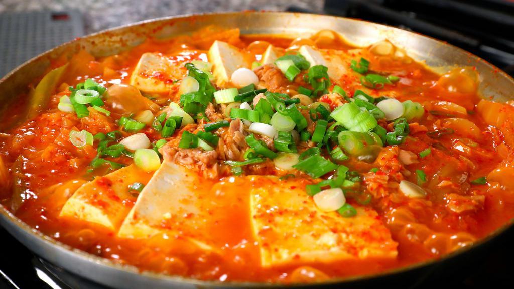 57. Kimchi Jigae · Spicy. Kimchi stew with pork, kimchi, tofu, and Vegetables with rice